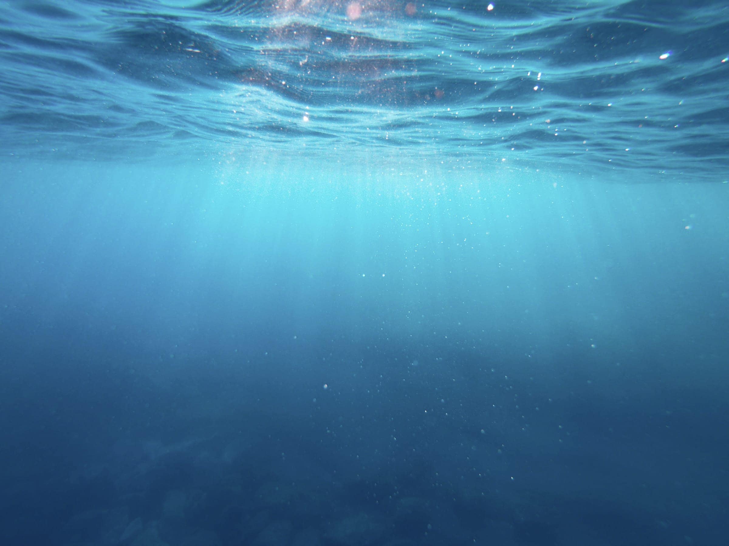 Light falling through deep blue water