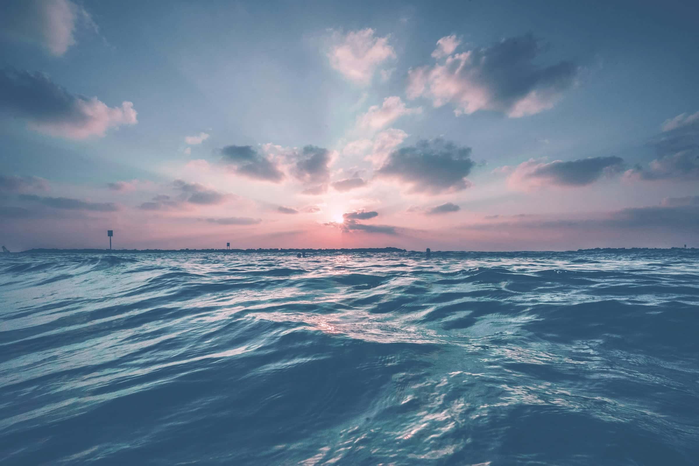 Waves rolling under a clouded evening sky